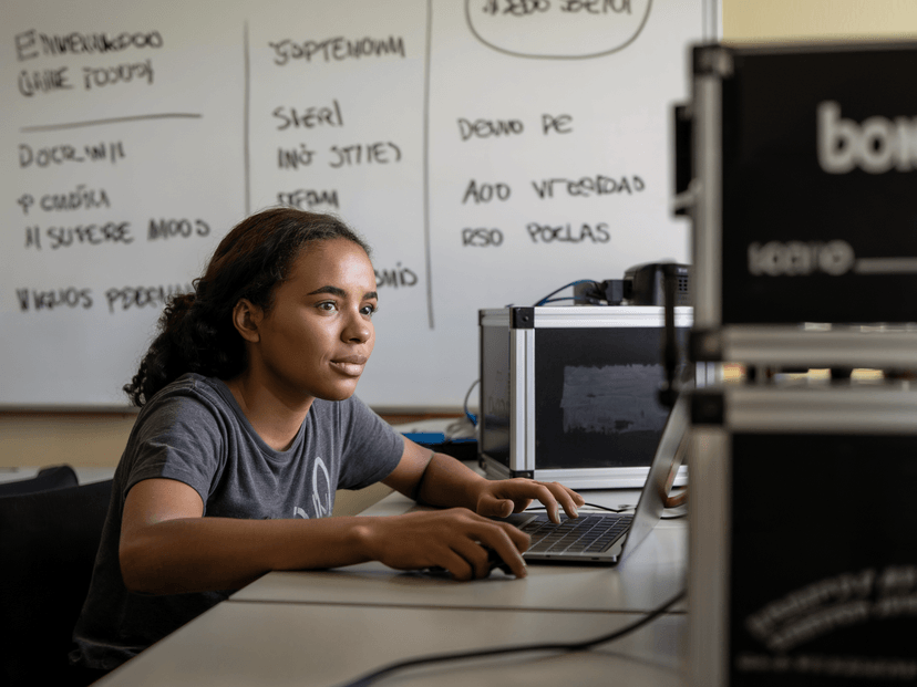 Teenager working on laptop learning professional skills
