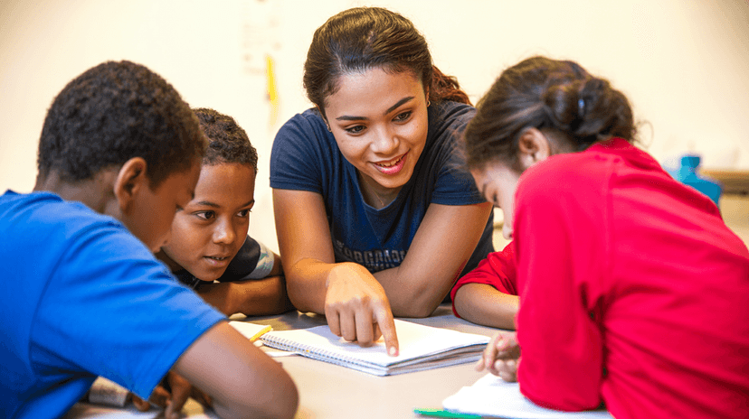Maria helping students with their homework